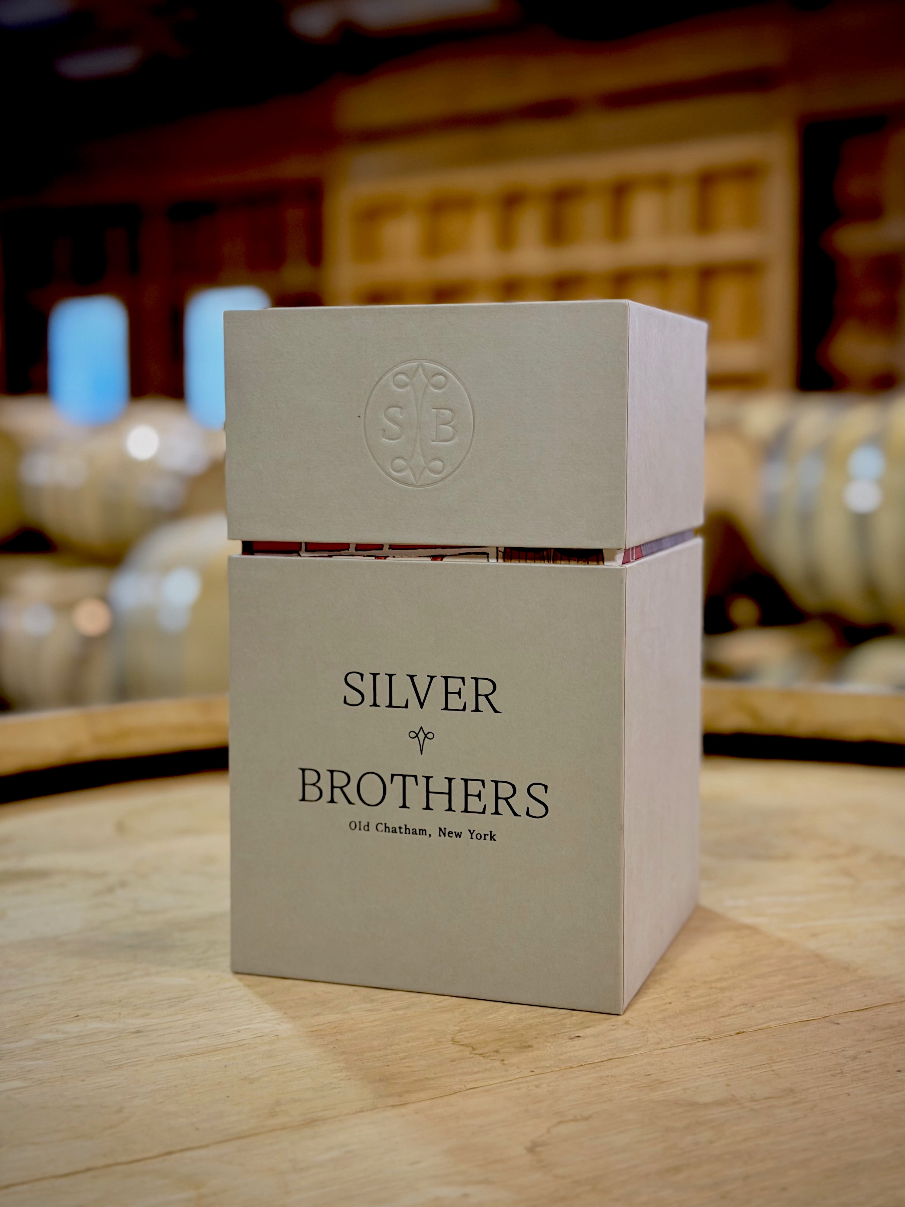 Box with 'Silver Brothers' branding on a wooden surface with blurred background